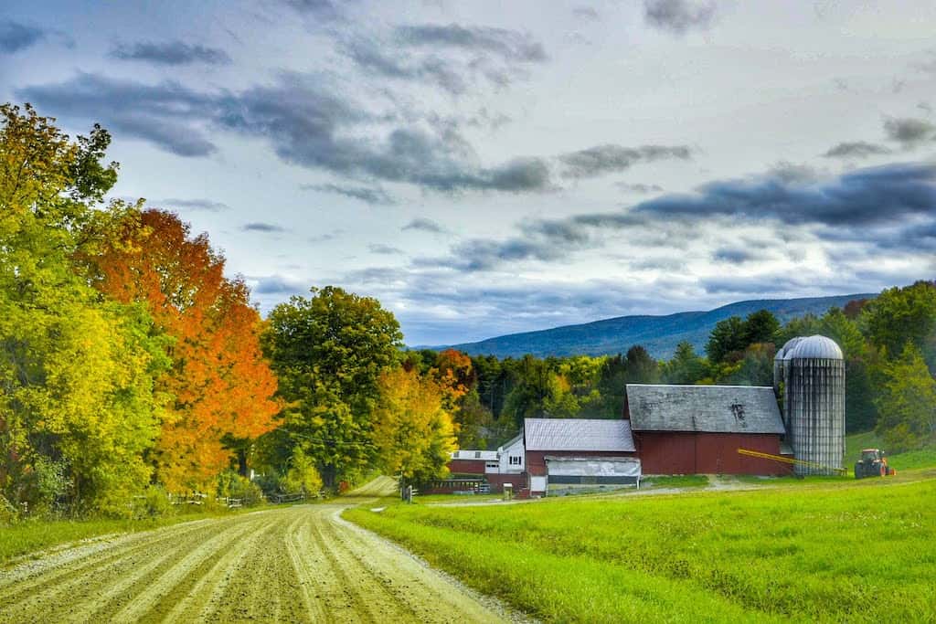 A farm surrounded by beautiful fall foliage in Bennington Vermont.