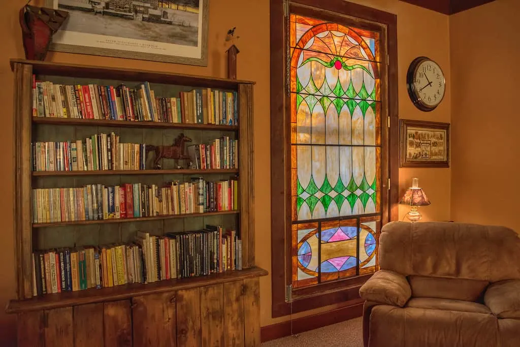  a cozy recliner next to a stained glass window?