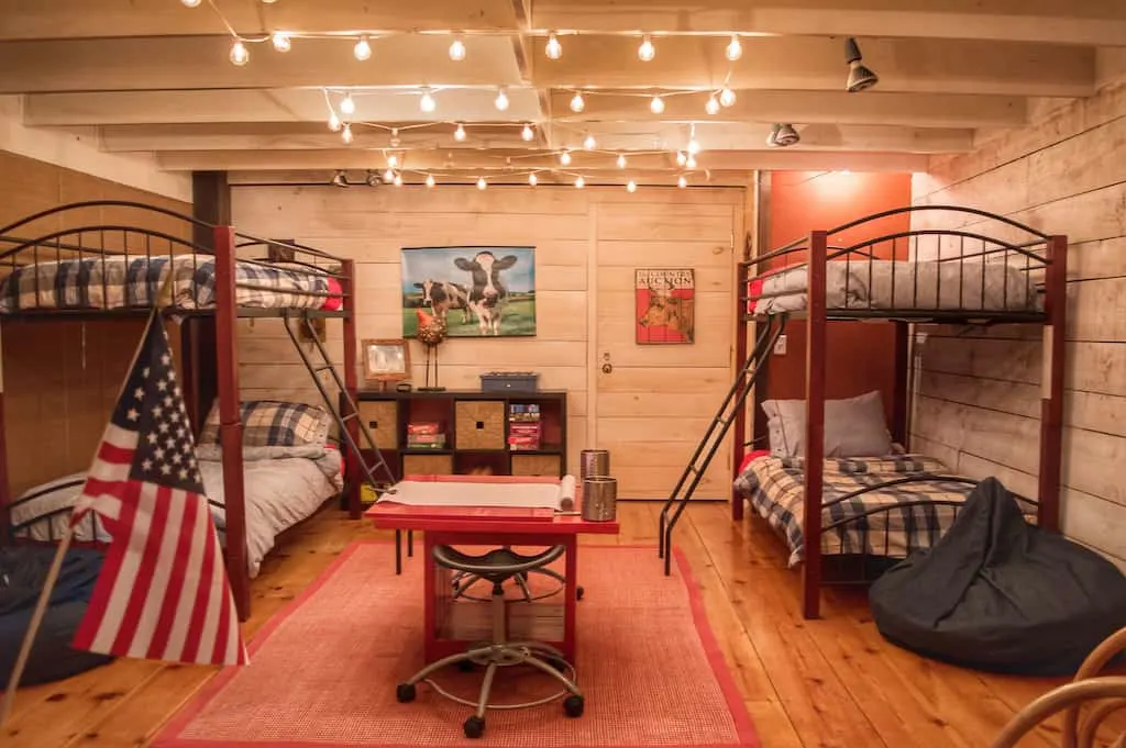 An interior shot featuring two sets of bunk beds surrounded by twinkling lights