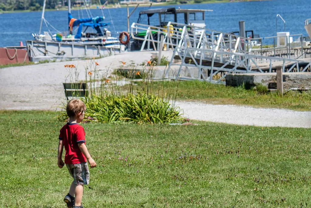 A child walking down to the water at Burton Island Marina in Vermont.