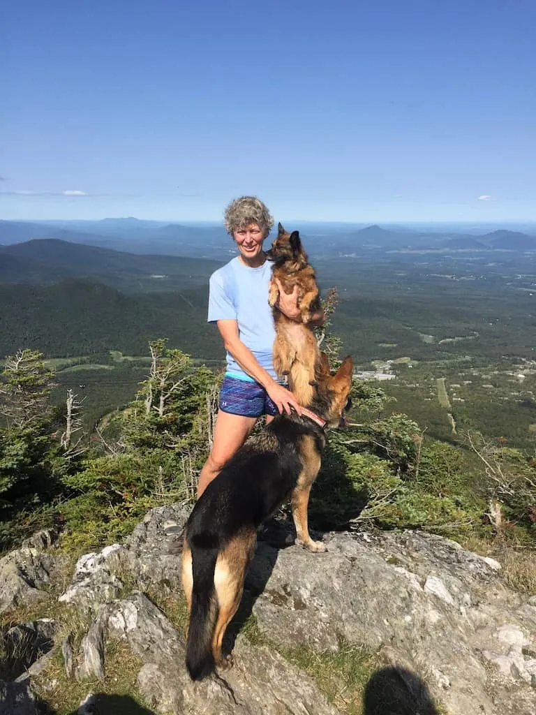 Shirley and her dogs stand on top of a mountain on Vermont's Long Trail.