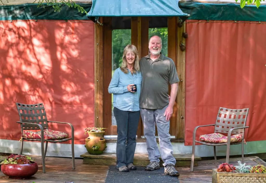 Hosts Ellen and Jay in front of their yurt rental in New Haven, Vermont.