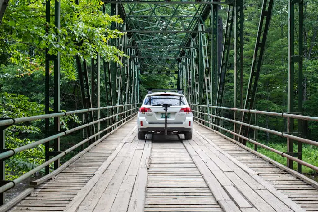 A car driving over the bridge that leads to Jamaica State Park in Vermont.