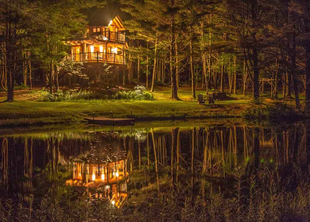 A night time view of Moose Meadow Treehouse near Waterbury, Vermont