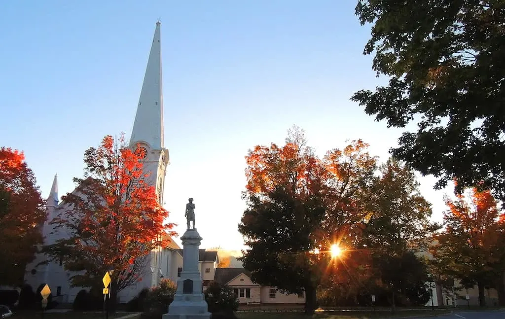 Sunrise over the church steeple in Manchester Village, Vermont in the fall.