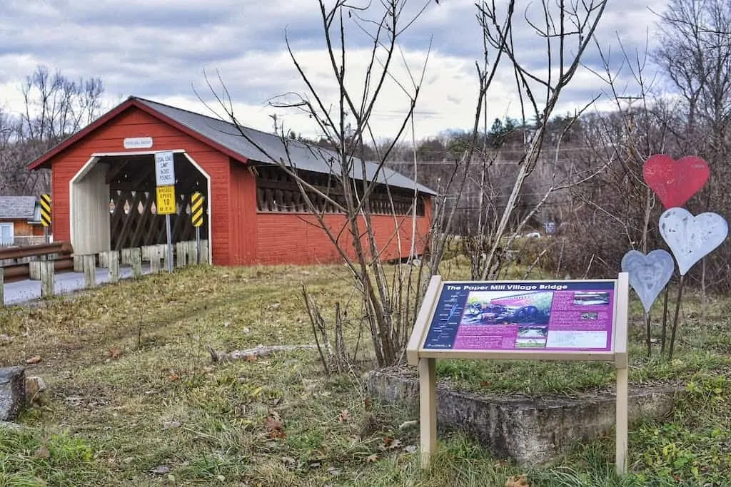 The Paper Mill Village Bridge and an informational sign in front of it. Bennington, Vermont.