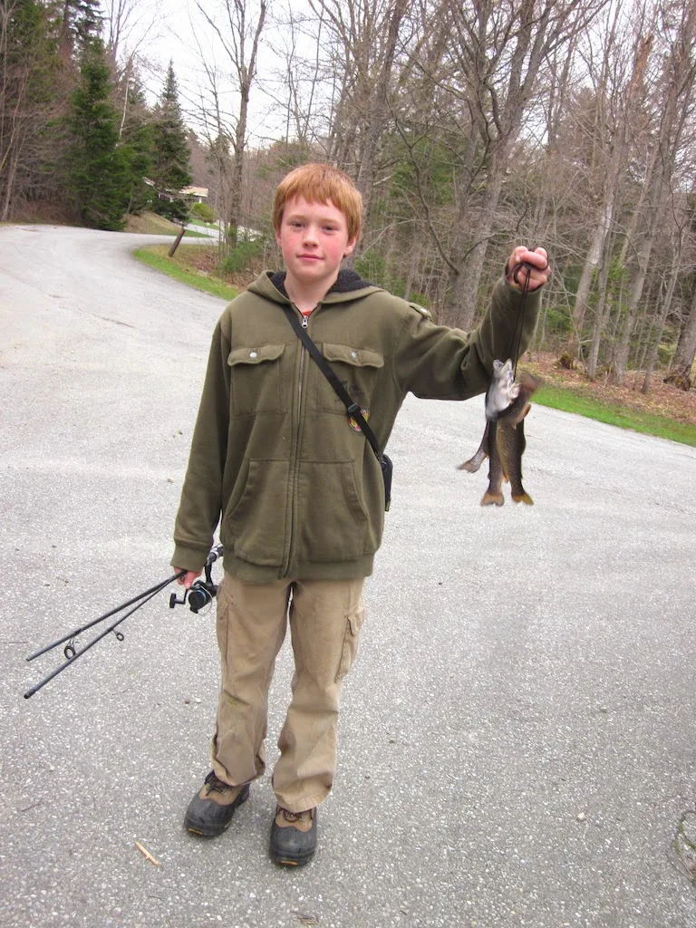 Rowan holding a few small trout at Woodford State Park in Vermont. 