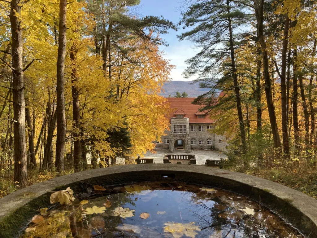 Fall foliage reflects off a small fountain at the Everett Mansion in Bennington, Vermont.