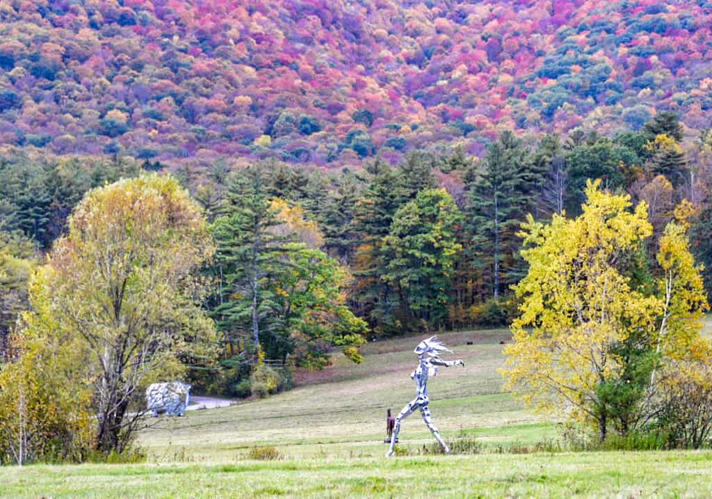 a larger than life sculpture of a women running through the fields at Southern Vermont Art Center in Manchester.