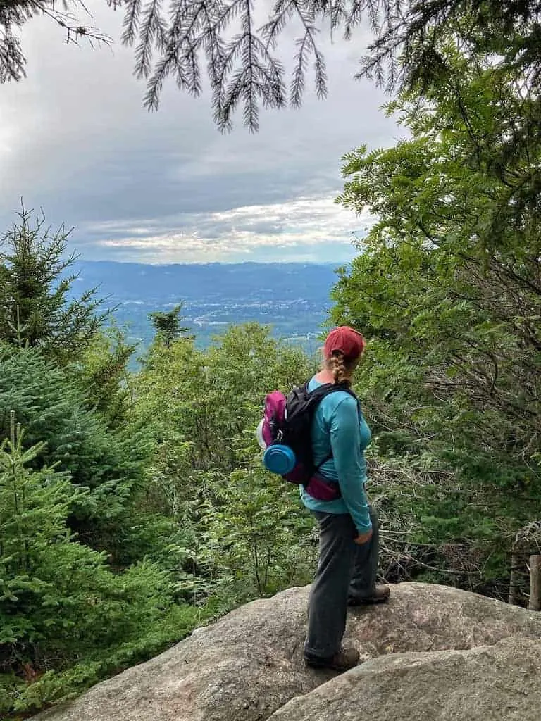 Tara standing on a rock looking at the view from Blue Ridge Mountain in Vermont. 