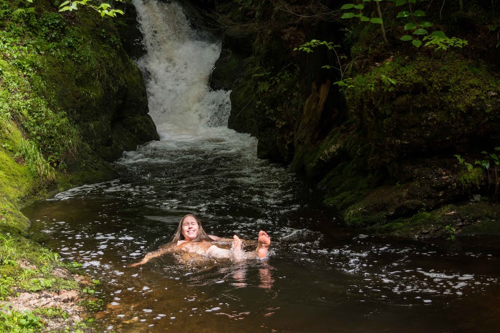 A woman enjoys a Vermont swimming hole in the Green Mountain National Foret. 