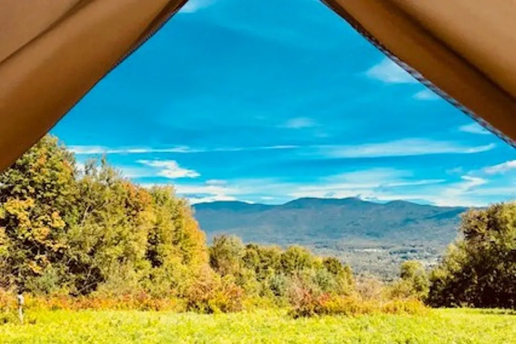 A fall foliage view of Vermont featuring a Tentrr glamping spot.