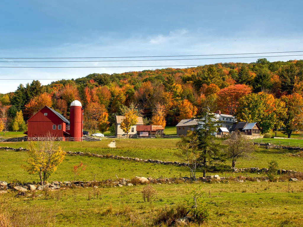 A fall foliage view of a small farm in Ludlow, Vermont on Route 100.