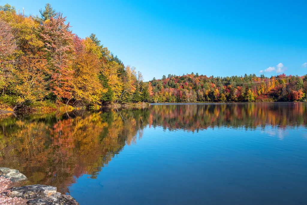 Waterbury Reservoir reflecting fall foliage in Vermont.