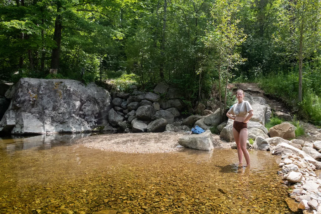 A woman stands ankle-deep in Benson Hole.