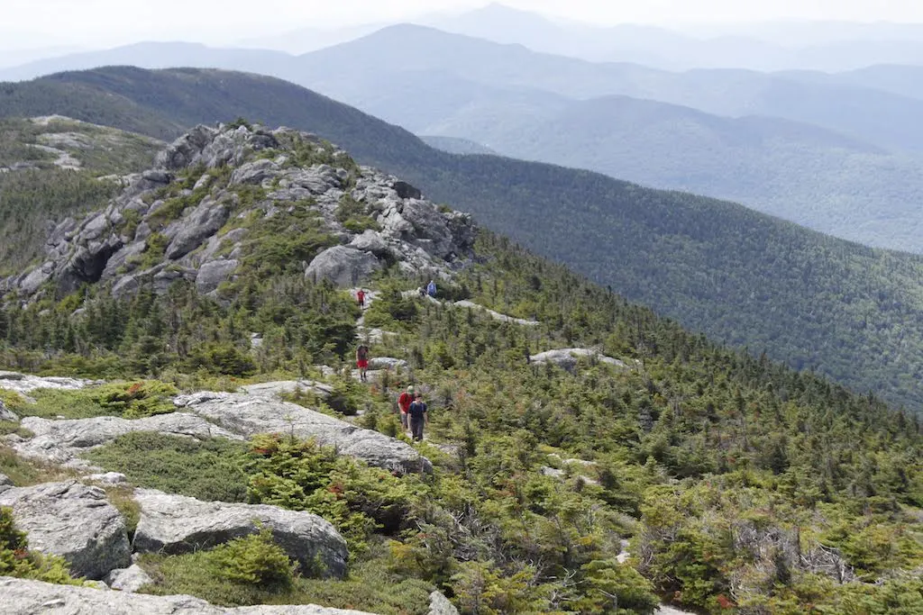 Hikers on the Long Trail going over Mount Mansfield.