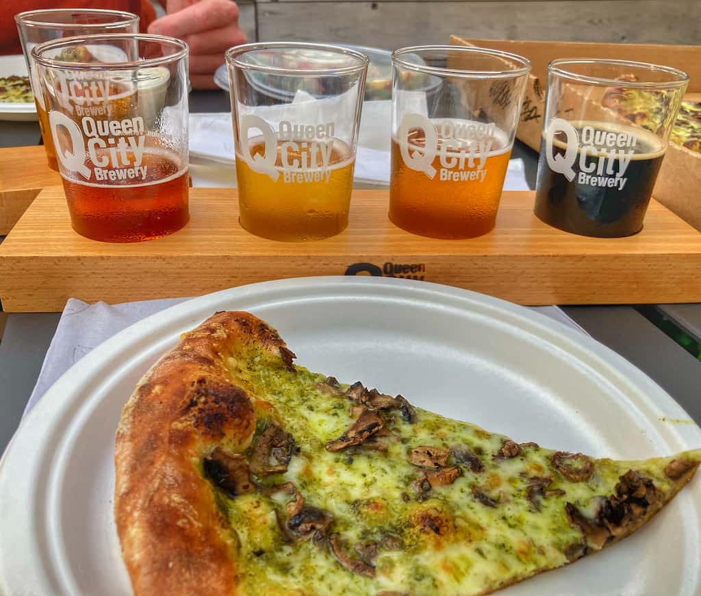 A flight of beers and a pesto pizza from Queen City Brewery in Burlington, Vermont.
