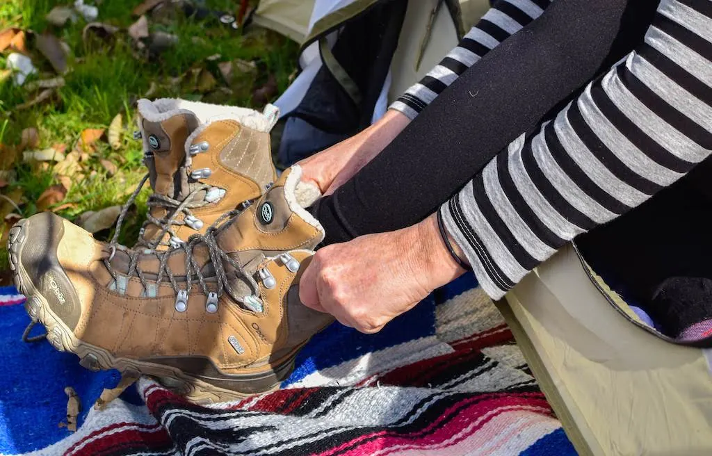 Putting on Oboz insulated boots in the fall.