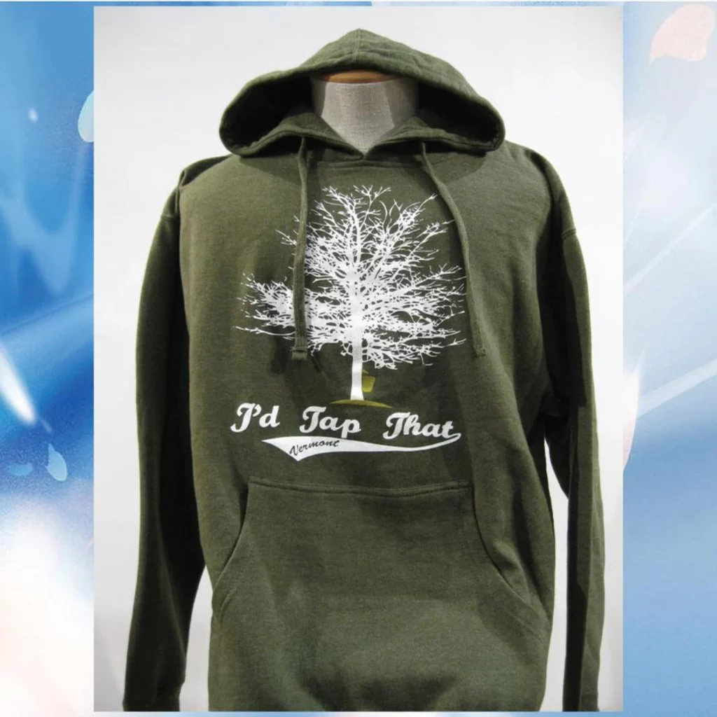 A green sweatshirt with an outline of a maple tree on it and the words, "I'd Tap That."