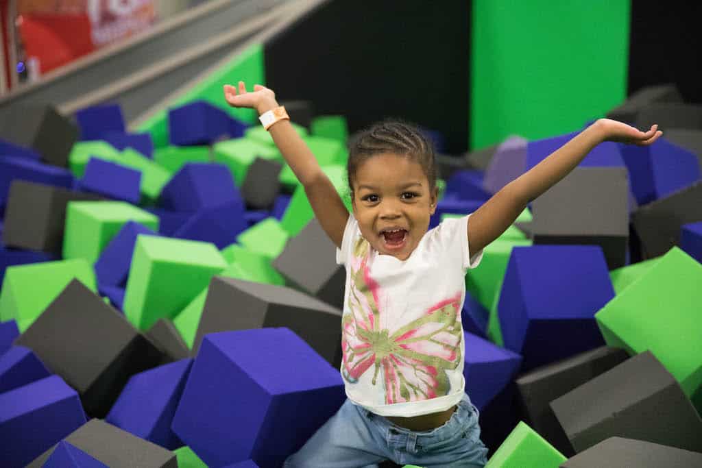 A young child enjoys the foam pit at Get Air Trampoline Park in Vermont.