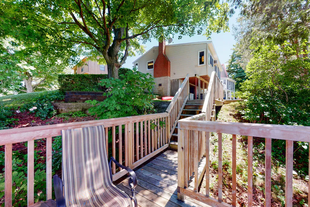 A large deck leading to a Lake Champlain Lake House.