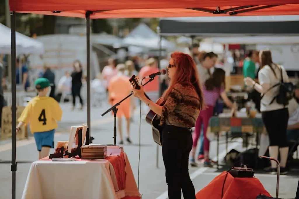 A singer/songwriter performs on a small stage at Mayfest in Bennington, Vermont.