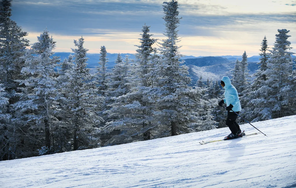 A person skiing at Stowe Mountain Resort in Vermont.