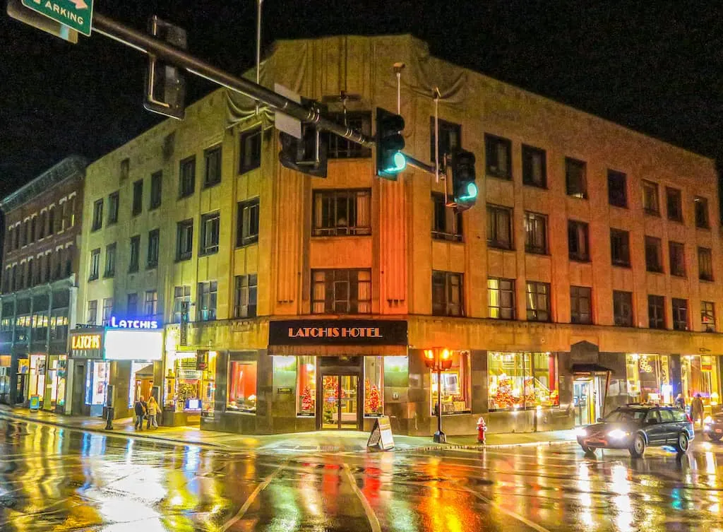 The Latchis Hotel in Brattleboro Vermont at night with street and traffic lights surrounding.
