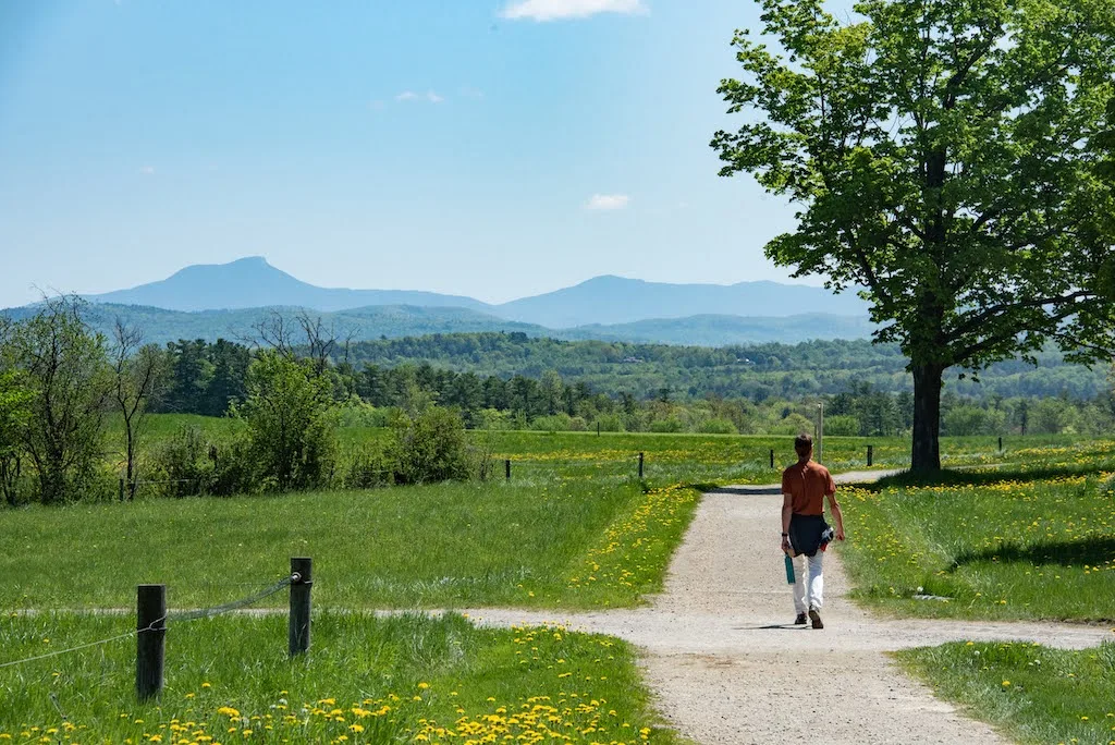 Eric walking on a path at Shelburne Farms in Vermont. 