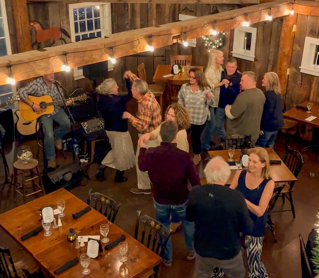 Several couples dancing to live music in the Phelps Barn Pub. 