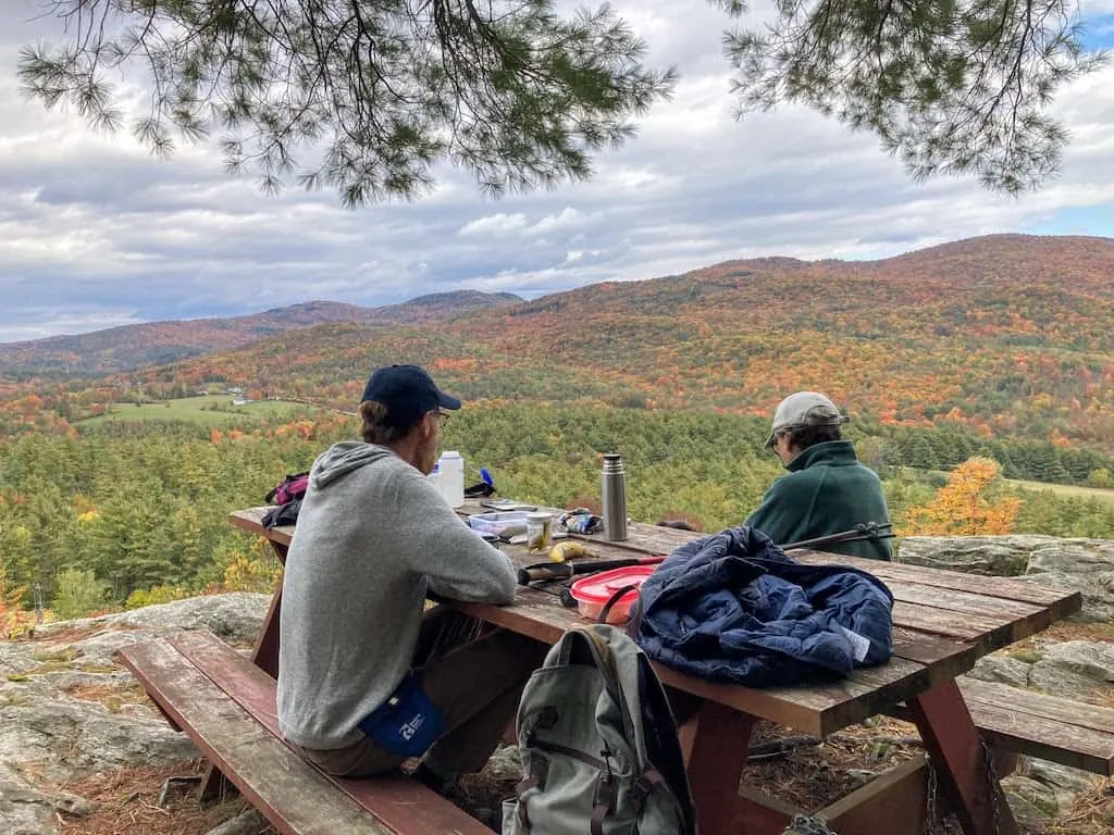 Enjoying fall foliage views from one of the best picnic spots in Vermont - on top of Mount Zion Major in Hubbardton.