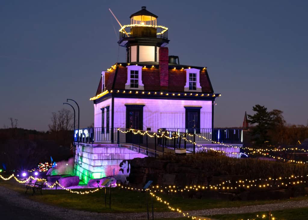 A lighthouse at the Shelburne Museum covered with twinkling lights as part of Winter Lights.