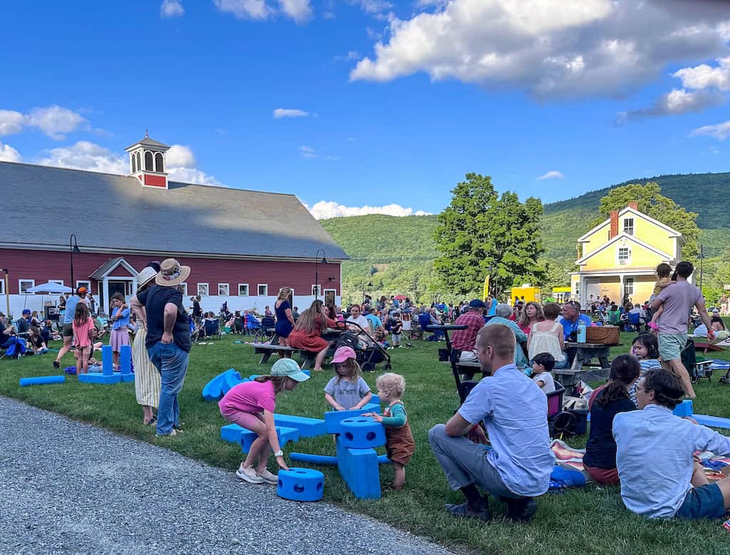 A crowd enjoys lawn games atnd music at Retreat Farm's Food Truck Roundup
