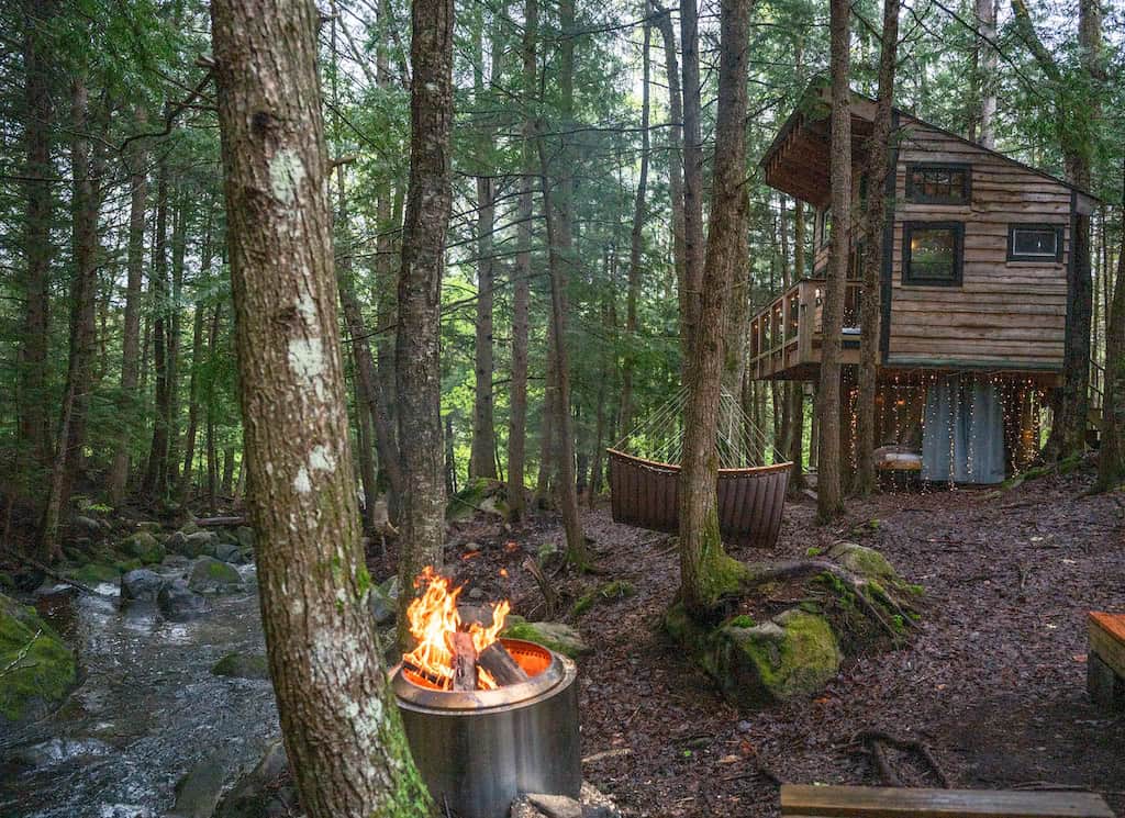 View of the treehouse from the riverside fire pit.