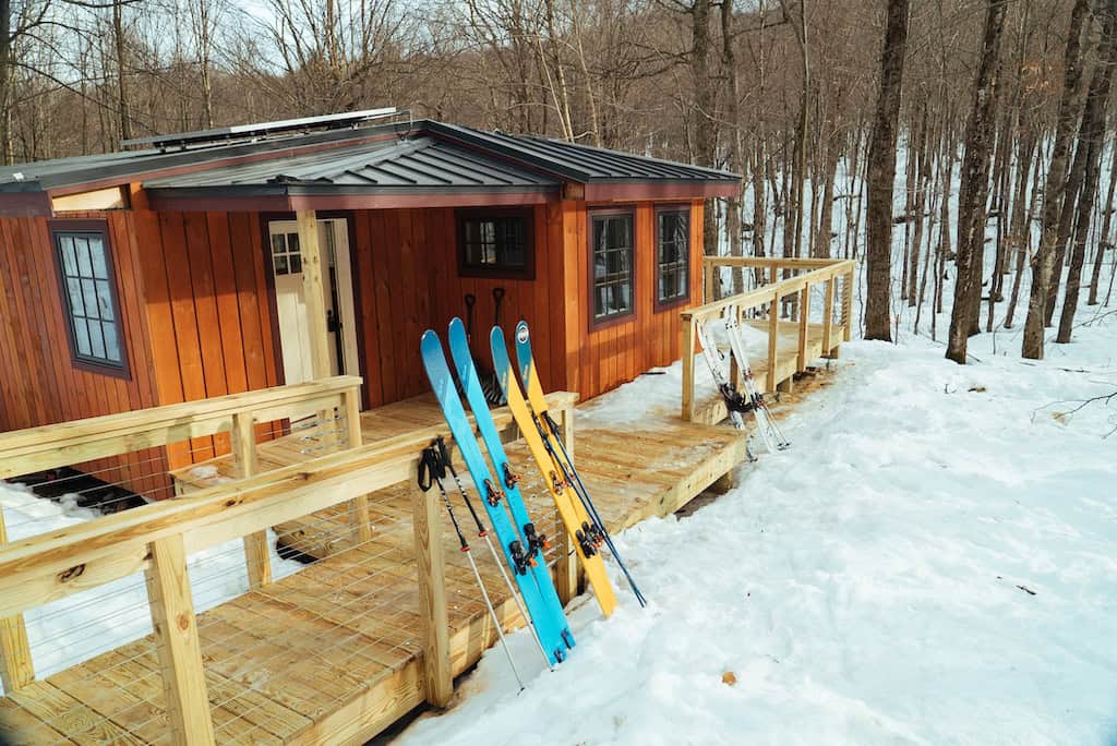 Winter at Chittenden Brook Hut covered with snow.