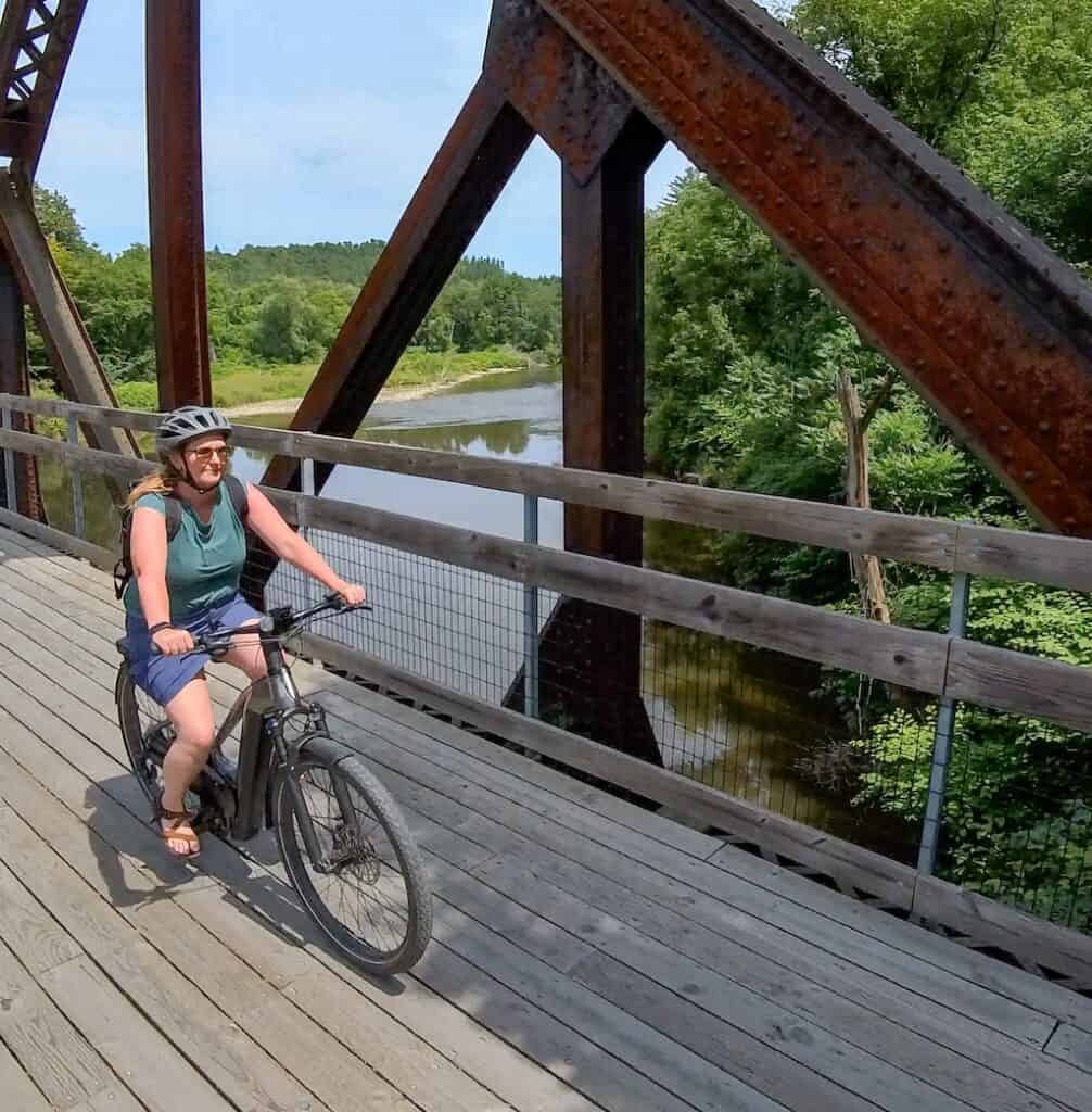 Tara on a bike riding over the Lamoille River near Hyde Park, VT.