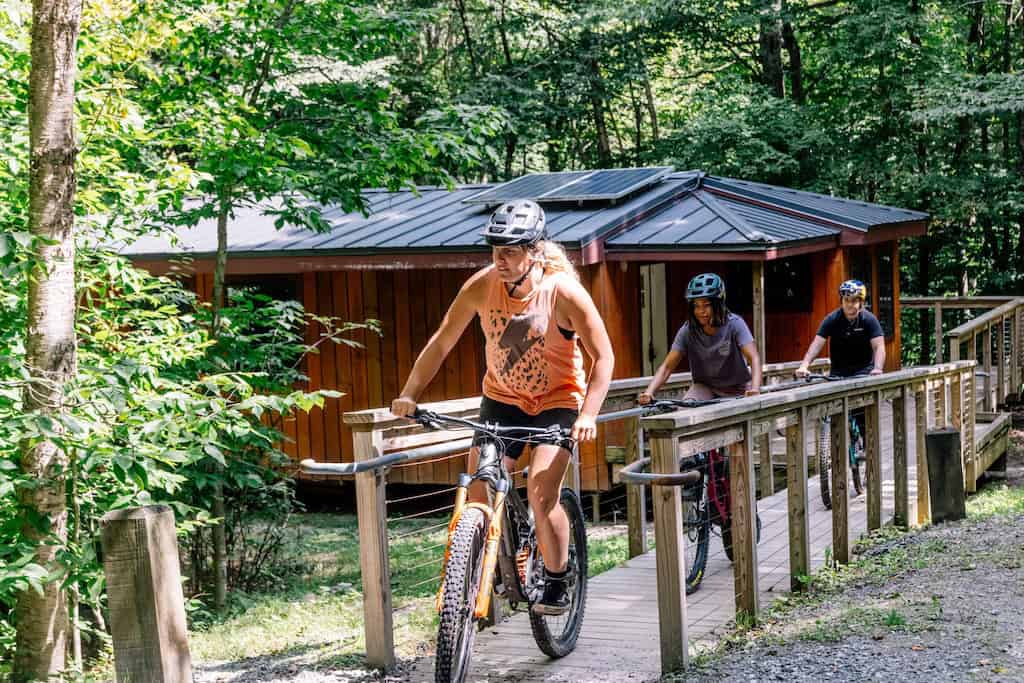 Cyclists leaving Chittenden Brook Hut.
