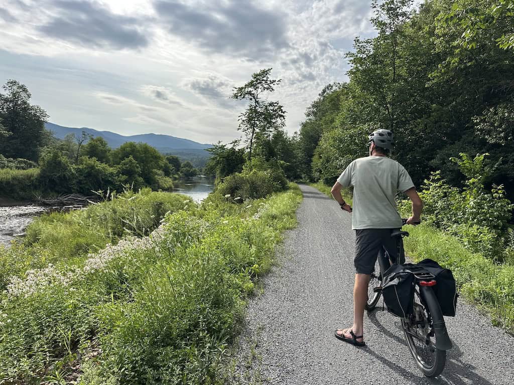 The Lamoille River, wildflowers, and mountain views on the Lamoille Valley Rail Trail near Hyde Park.