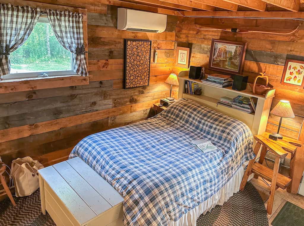 Full-size bed on the main floor of the cabin.