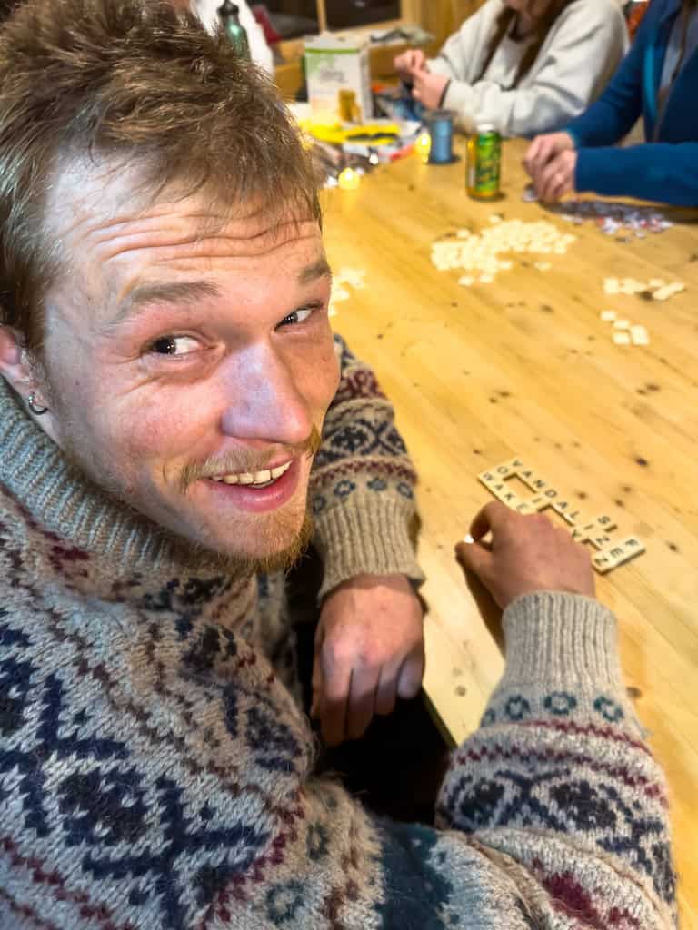 Rowan playing Bananagrams in the Grout Pond Hut. 