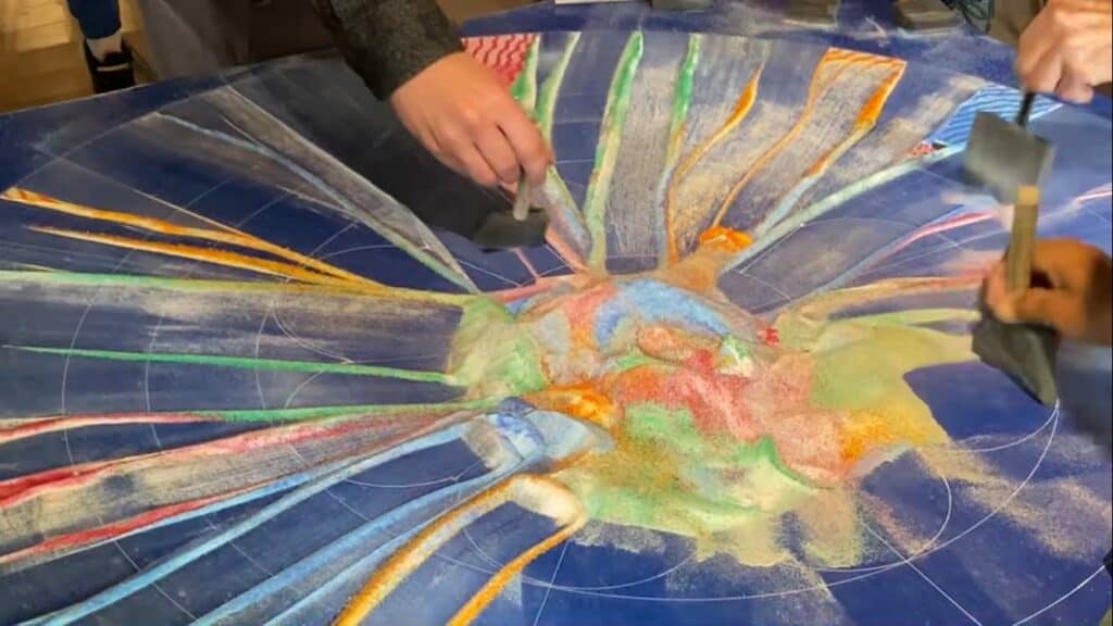 Sweeping away the sand mandala.